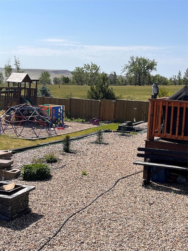 view of yard featuring a playground and fence