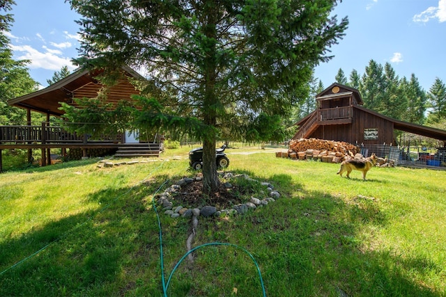 87 Badger Trl, Eureka, MT 59917 - view of green lawn with a wooden deck and a barn