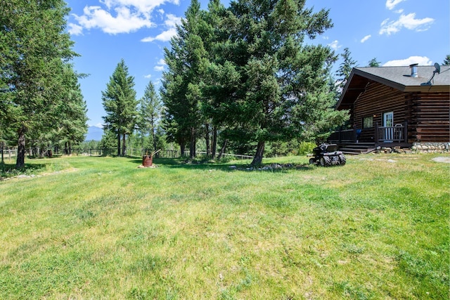 87 Badger Trl, Eureka, MT 59917 - view of green lawn featuring a deck