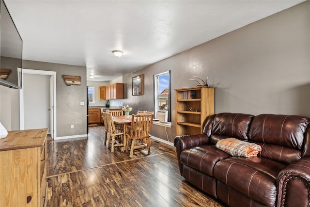 living room with dark wood finished floors and baseboards