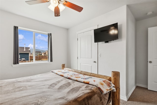 carpeted bedroom featuring a closet and ceiling fan