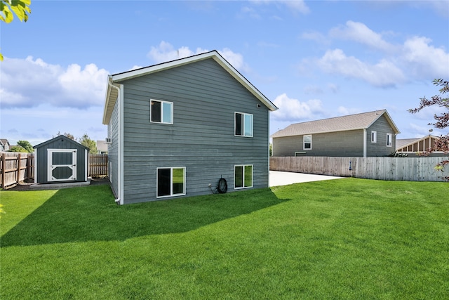 rear view of house with a storage shed, a lawn, and a patio