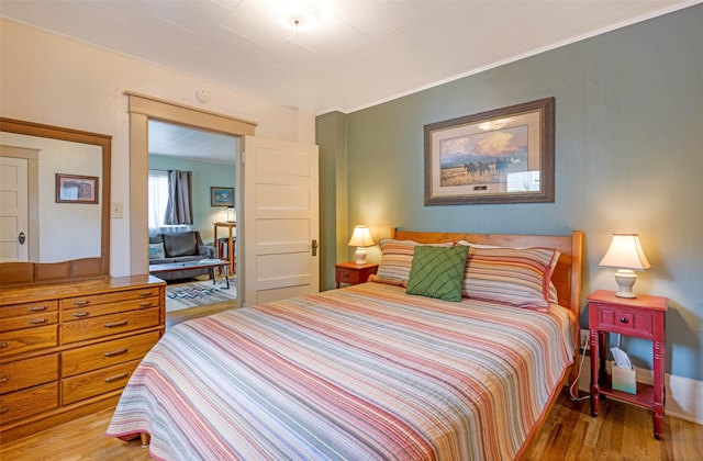 bedroom with hardwood / wood-style floors