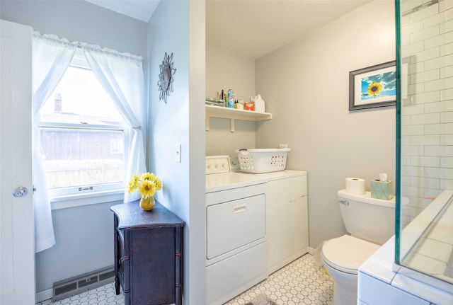 bathroom with tile patterned flooring, washer and dryer, toilet, and vanity