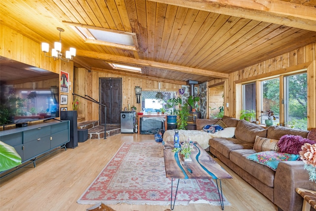 living room with wood ceiling, light hardwood / wood-style flooring, wooden walls, and vaulted ceiling with skylight