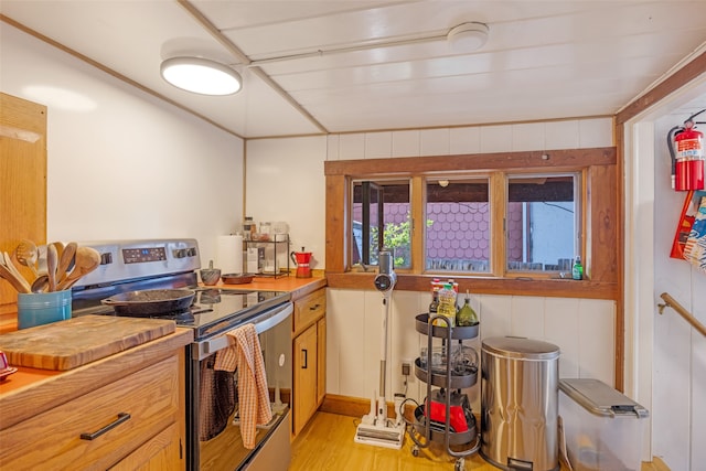 kitchen featuring light wood-type flooring and stainless steel electric range oven