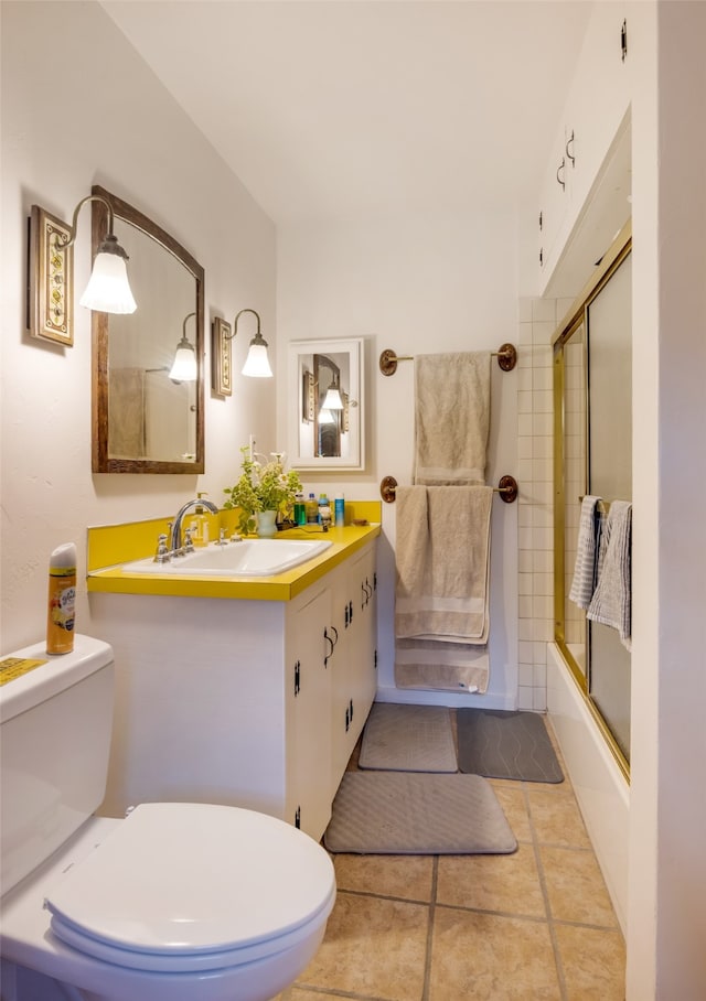 full bathroom featuring vanity, toilet, tile patterned floors, and enclosed tub / shower combo