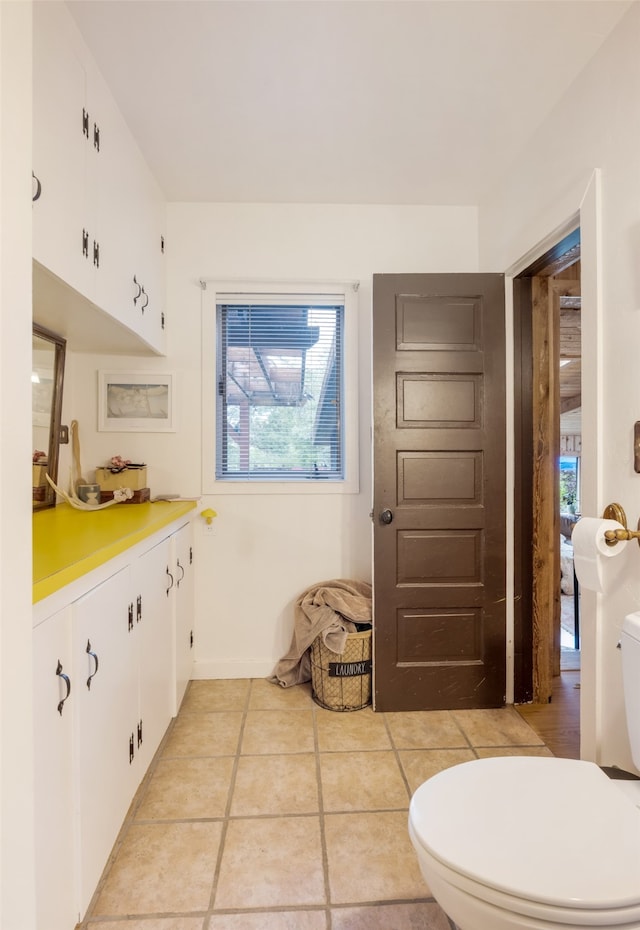 bathroom with tile patterned floors, toilet, and vanity