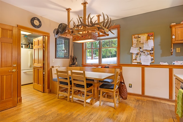 dining area with a chandelier and light wood-type flooring