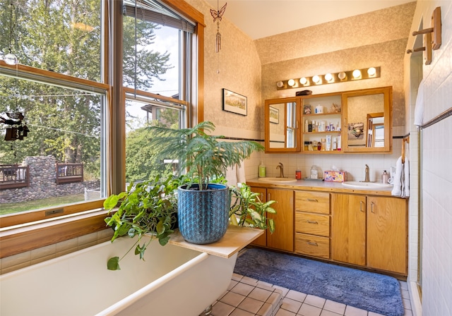 bathroom with tile patterned flooring, tile walls, dual vanity, and tasteful backsplash