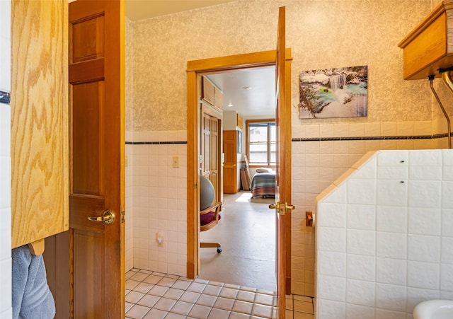 bathroom with tile patterned flooring and tile walls