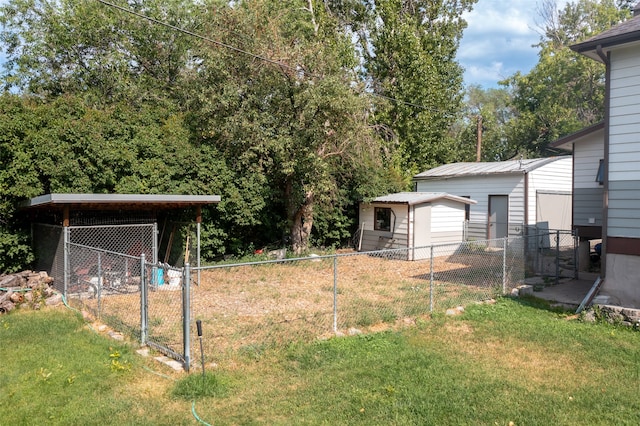 view of yard with a garage and an outbuilding