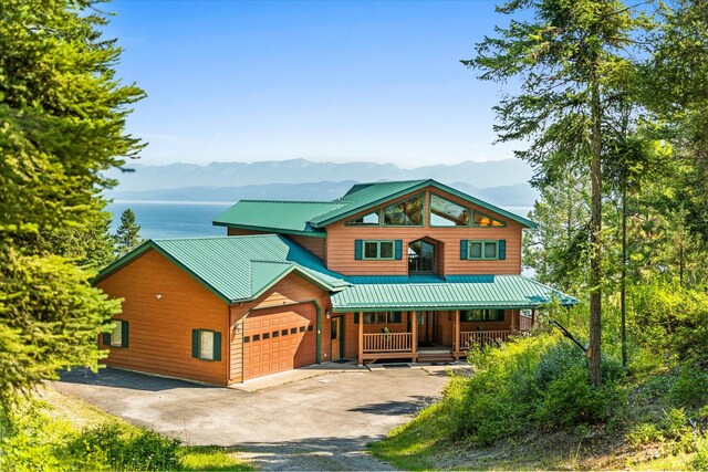 view of front of property with a mountain view, a garage, and covered porch