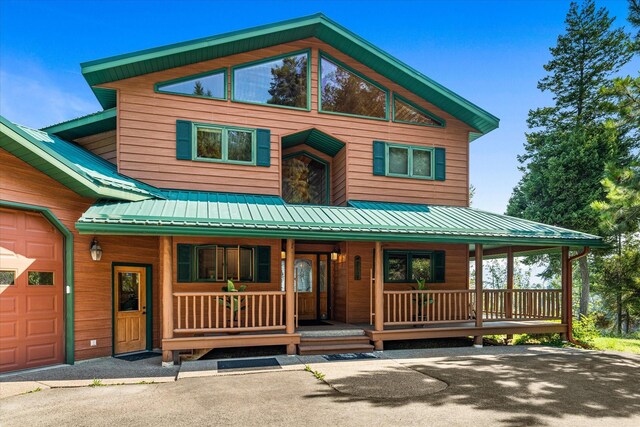 view of front facade featuring covered porch and a garage