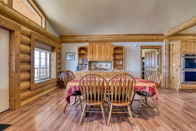 dining area with lofted ceiling, light wood-style flooring, visible vents, and log walls