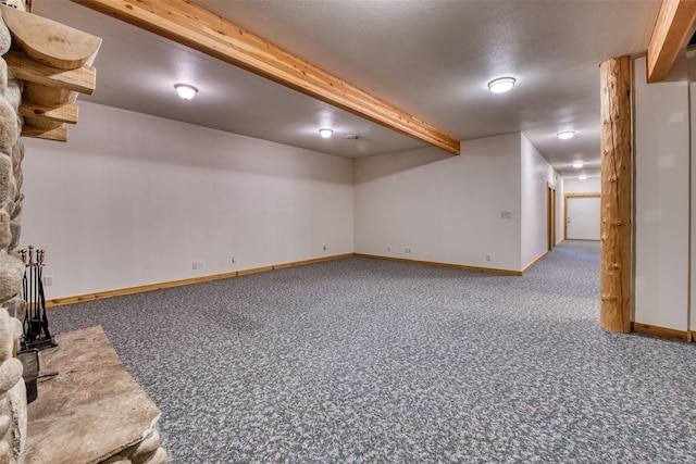 finished basement featuring carpet flooring, a textured ceiling, and baseboards