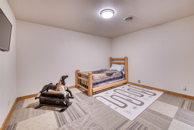 bedroom with carpet floors, visible vents, and baseboards