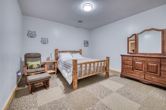 carpeted bedroom with visible vents and baseboards