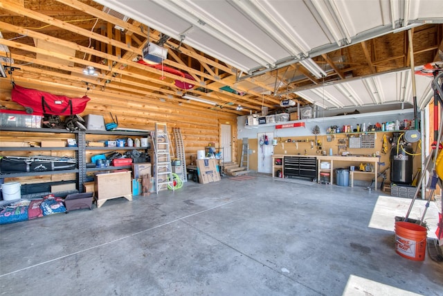 garage with a garage door opener and a workshop area