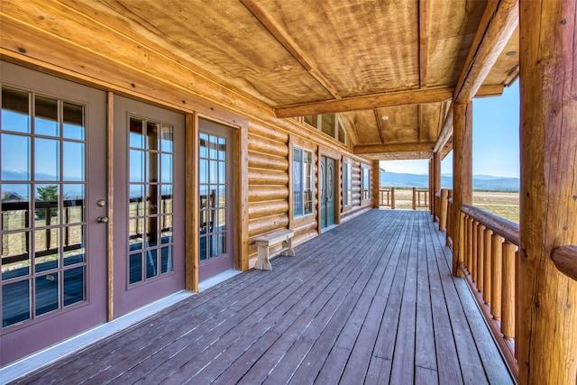 wooden terrace featuring a mountain view and french doors