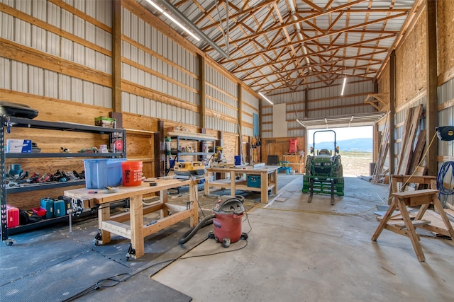 garage featuring metal wall, a mountain view, and a workshop area