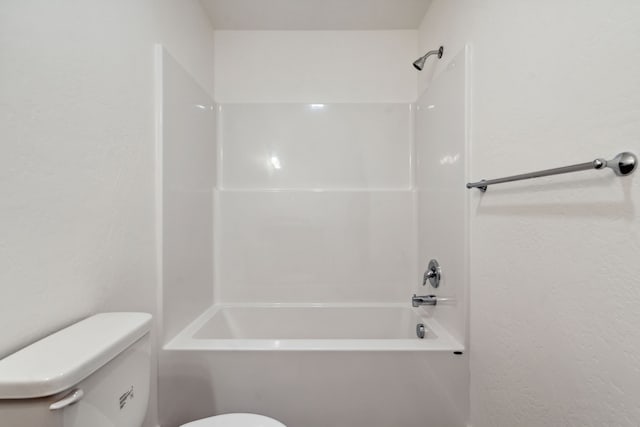 bathroom featuring bathtub / shower combination and toilet