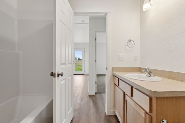 bathroom with shower with separate bathtub, vanity, and hardwood / wood-style floors