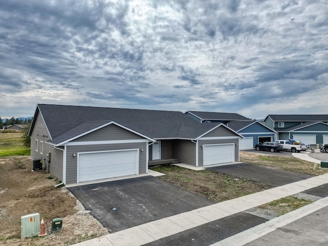 view of front facade with cooling unit and a garage