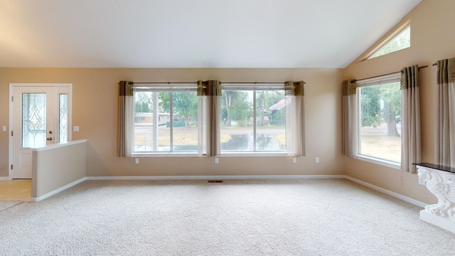 spare room with lofted ceiling and light colored carpet