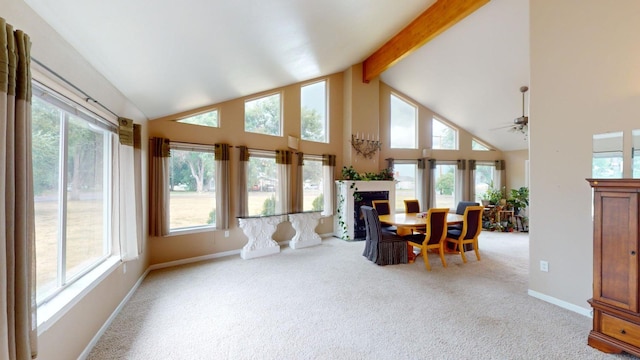 sunroom / solarium with a healthy amount of sunlight and vaulted ceiling with beams