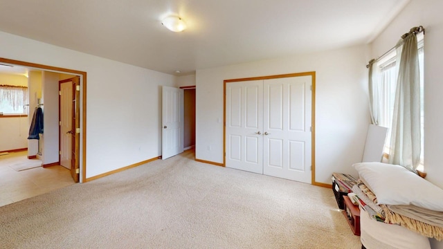 carpeted bedroom with multiple windows and a closet