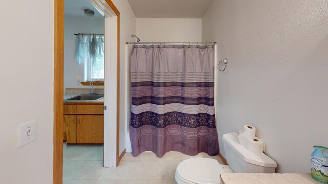 bathroom with walk in shower, vanity, toilet, and tile patterned flooring