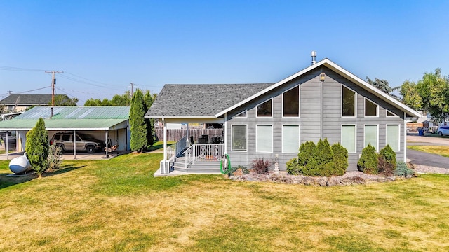 back of house with a carport and a lawn