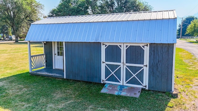 view of outbuilding with a lawn