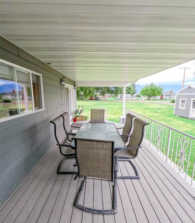 deck with a lawn and a porch