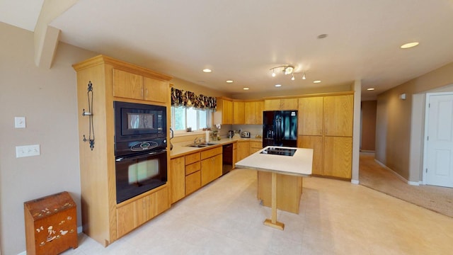 kitchen with a kitchen island, sink, light brown cabinetry, and black appliances