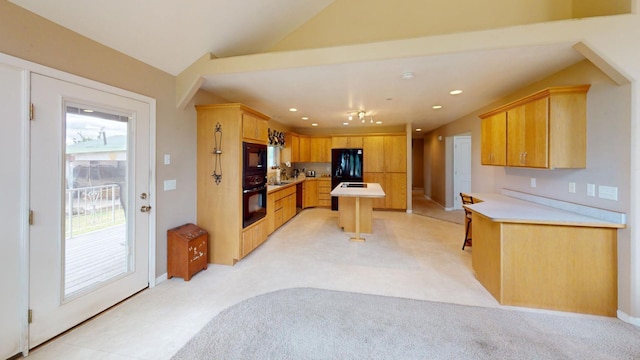 kitchen featuring vaulted ceiling, sink, a center island, black appliances, and light brown cabinets