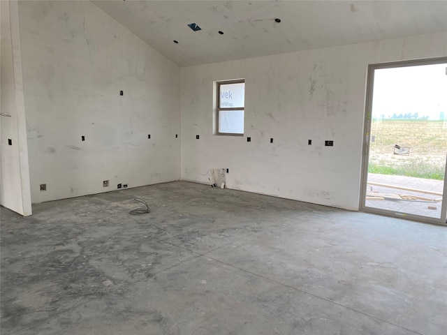 empty room featuring lofted ceiling