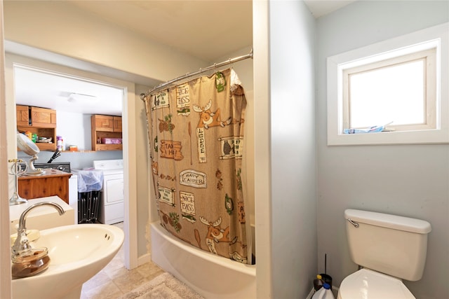 full bathroom featuring sink, washer / clothes dryer, shower / tub combo with curtain, tile patterned floors, and toilet