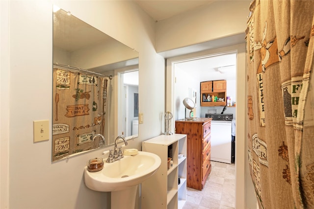 bathroom with sink, washer / dryer, and tile patterned flooring