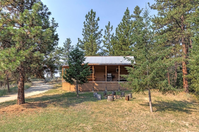 log cabin featuring a front lawn