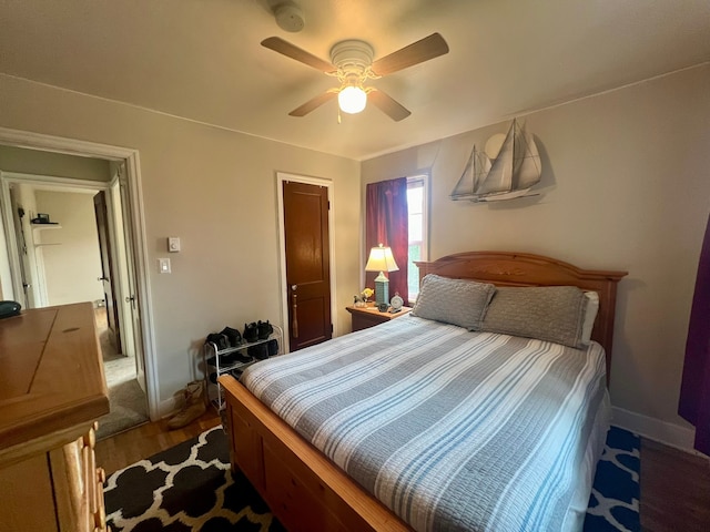 bedroom with dark hardwood / wood-style floors and ceiling fan