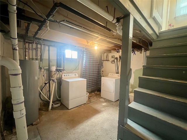 basement featuring water heater and washer and dryer