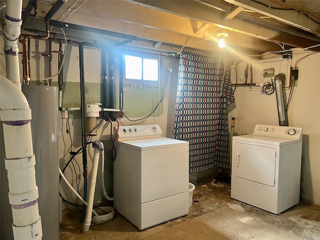 basement with washing machine and dryer and water heater