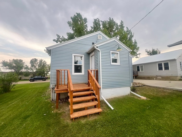 rear view of property featuring a yard