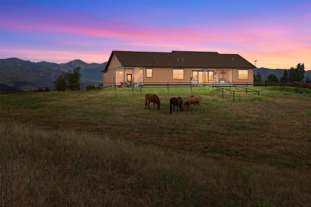 back house at dusk with a mountain view