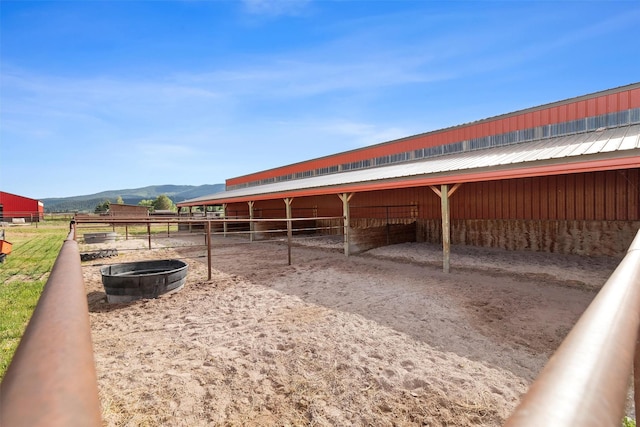 view of stable with a mountain view and a rural view