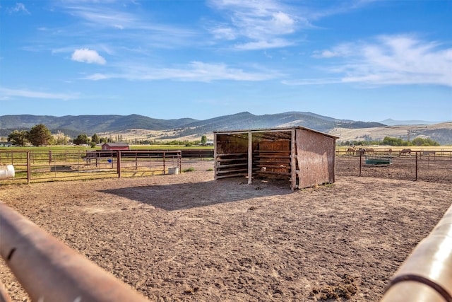 view of stable with a mountain view and a rural view