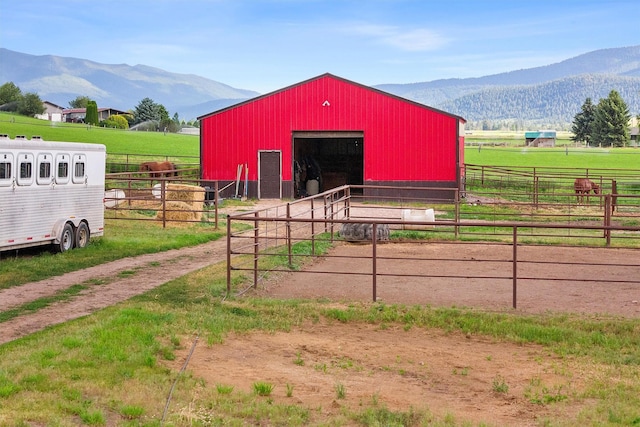 view of stable with a mountain view and a rural view