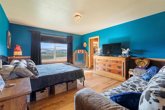 bedroom featuring hardwood / wood-style flooring and a textured ceiling